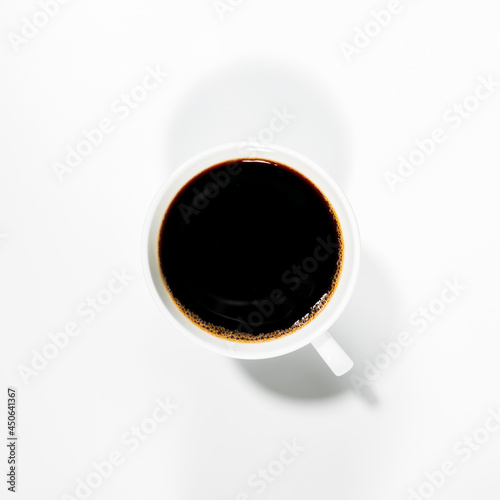 photos of black coffee in a white cup from above that separate the white background. isolated photo