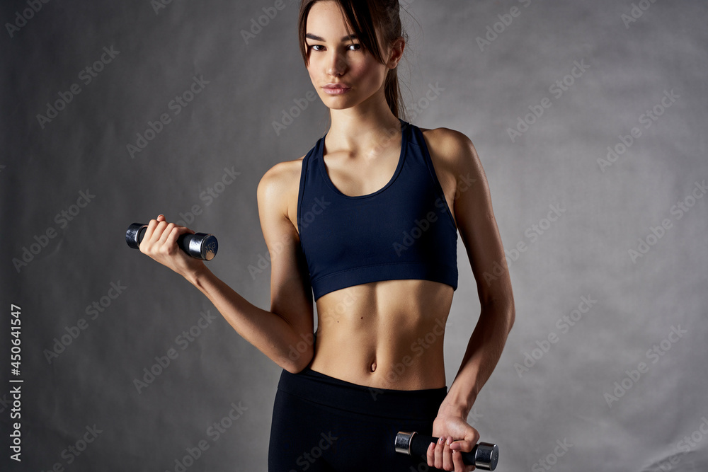 athletic woman with a slim figure with dumbbells in the hands of fitness workout athletic woman with a slim figure with dumbbells in the hands of fitness workout