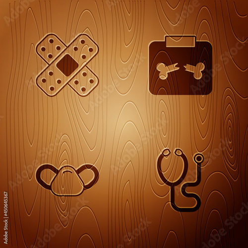 Set Stethoscope, Crossed bandage plaster, Medical protective mask and X-ray shots with broken bone on wooden background. Vector