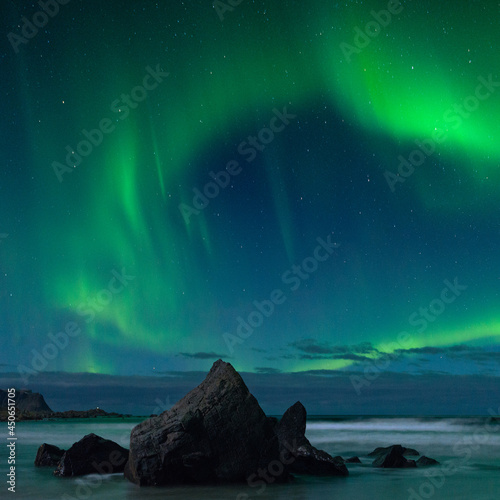 rock on the beach with northern light
