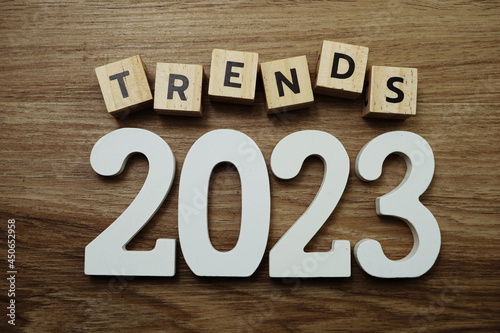 Trends 2023 word alphabet letters on wooden background