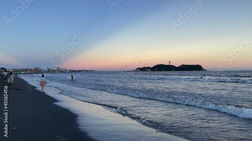FUJISAWA, KANAGAWA, JAPAN - JULY 2021 : View of beach and magic hour sky at Shonan area near Enoshima island. Wide view, real time shot in dusk. photo