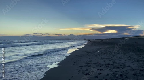 FUJISAWA, KANAGAWA, JAPAN - JULY 2021 : View of beach and magic hour sky at Shonan area near Enoshima island. Wide view, real time shot in dusk. photo