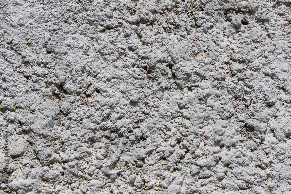 Close-up of decorative wall plaster. Abstract gray texture. Contrasting shadows on a bright sunny day Close-up of decorative wall plaster. Abstract gray texture. Contrasting shadows on a bright sunny day