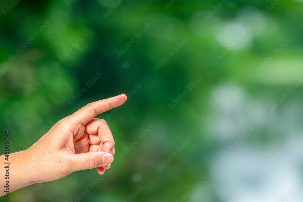 Man Hand over blur nature background, Hand holding object with fingers over blur nature background with empty space. Man Hand over blur nature background, Hand holding object with fingers over blur nature background with empty space.