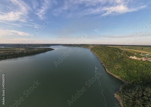 Landscape aerial view of the huge river Dnister with the tall trees around. Panoramic view.