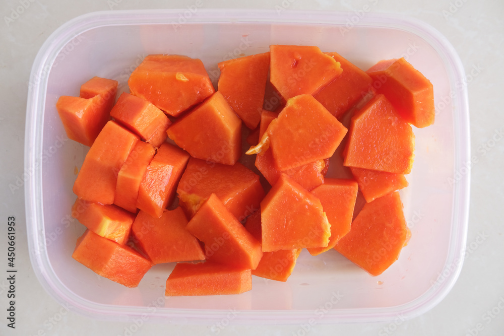 Fresh cut papaya fruit in a plastic container. Top view Fresh cut papaya fruit in a plastic container. Top view