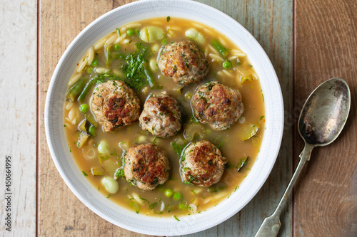 Green minestrone sopu with meat balls and orzo pasta