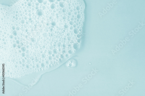 Foam soap shampoo  gel. Blue tone cosmetic background.