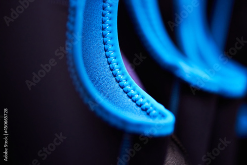 Canvas-taulu Closeup macro of wetsuits hung up on coat hangers in a wet room cloak room with