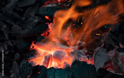 Close-up flames and embers of charcoal. Barbecue in the garden.