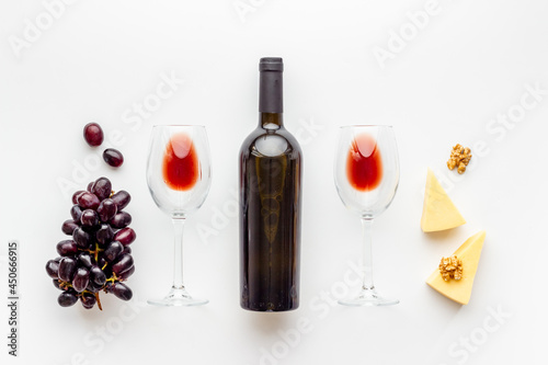 Grape and wine glasses with bottle of red wine