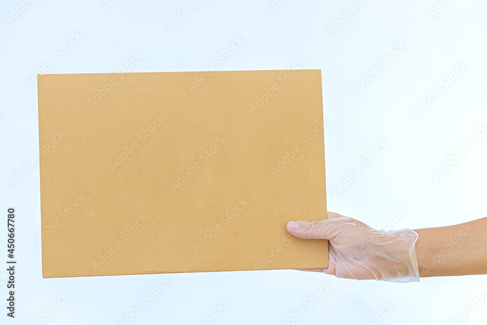 A woman's hand in medical gloves holds a paper envelope Amazon on white background. Express delivery. The courier brought the package . Online order. Home delivery A woman's hand in medical gloves holds a paper envelope Amazon on white background. Express delivery. The courier brought the package . Online order. Home delivery