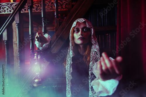 Fototapeta Naklejka Na Ścianę i Meble -  redhead witch with lantern