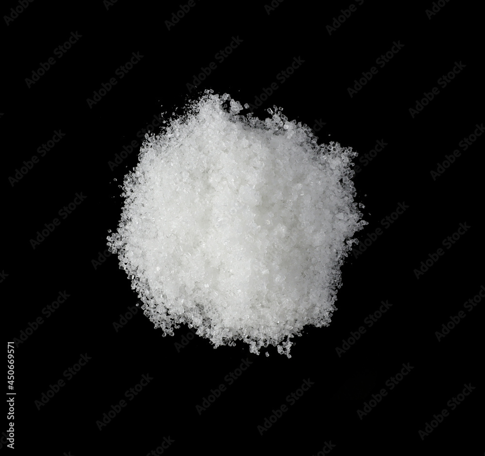 the pile white sugar on a black background	
