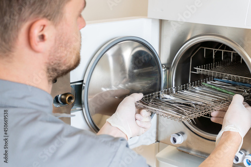 Sterilization of dentall instrument with ultraviolet lamp in dental clinic, autoclave sterilizing machine for dental tools to clean. cless B/ high quality.