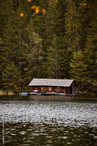 wilderness wooden house by a lake in the mountains © Johny