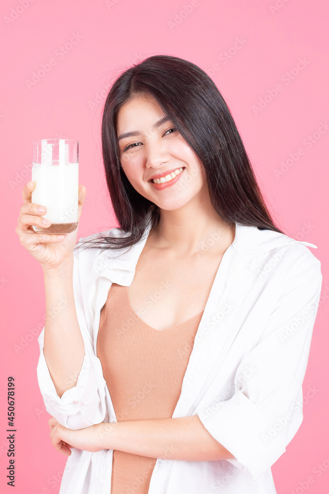 beautiful Asian woman cute girl feel happy drinking milk for good health in the morning on pink background - lifestyle beauty woman concept beautiful Asian woman cute girl feel happy drinking milk for good health in the morning on pink background - lifestyle beauty woman concept