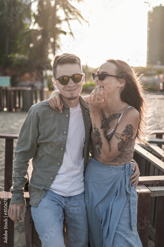 Wallpaper Mural Lovely stylish couple laughing on the beach. Portrait. Millennial. Wearing casual clothes and sunglasses. High quality photo Torontodigital.ca