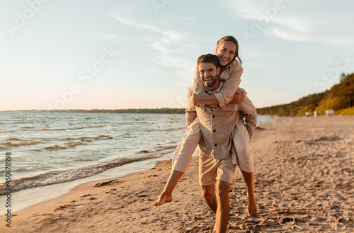Photography leisure and people concept - happy couple having fun on summer beach