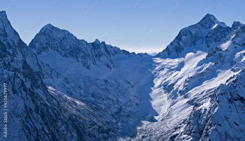 Snow-capped mountain peaks of the Caucasus Mountain Range. Northern snowy mountains of the Caucasus. Snow-capped mountain peaks of the Caucasus Mountain Range. Northern snowy mountains of the Caucasus.