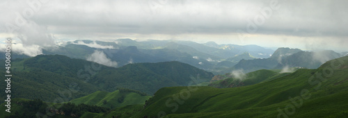 Mountains of the North Caucasus of Russia. Russian nature. Green valleys panoramic view. In the clouds and fog.