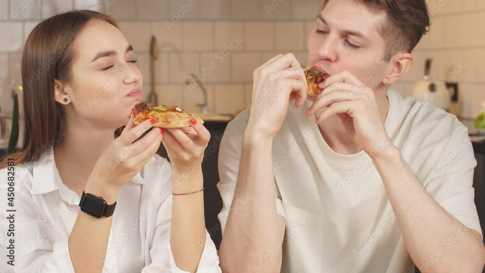 Happy family ordered pizza at home, they enjoy having meal together. Delivery, pizza, food, relationships concept. Happy family ordered pizza at home, they enjoy having meal together. Delivery, pizza, food, relationships concept.