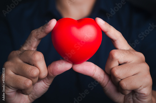 Hands of holding red heart shape. Close-up photo. Sign of love  healthcare  valentine s day  world heart day concept