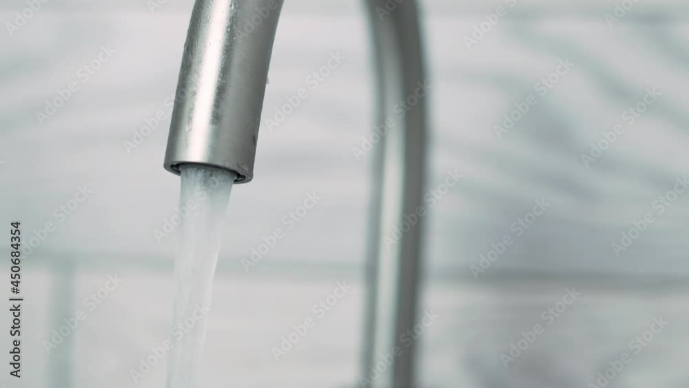 Water Runs from the Tap, Macro. A Stream of Water Flows from An Open Tap. Water Runs from the Tap, Macro. A Stream of Water Flows from An Open Tap.