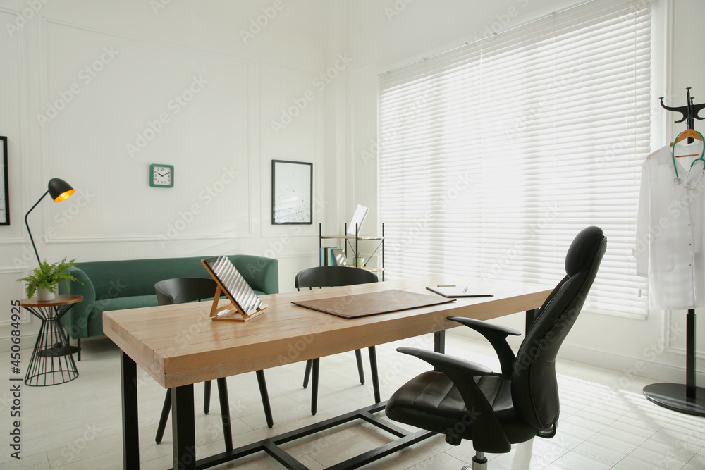 Modern medical office interior with doctor's workplace and sofa Modern medical office interior with doctor's workplace and sofa