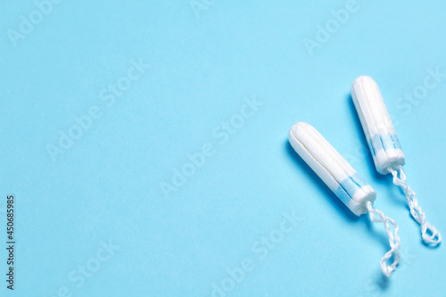 Tampons on a blue background. Feminine hygiene during menstruation. Template Copy space for text