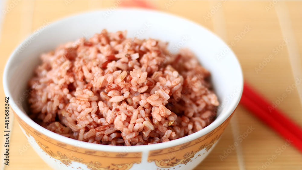 Steamed red rice on white bowl. Steamed red rice on white bowl.
