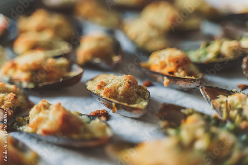 Baked stuffed fresh mussels in shell.