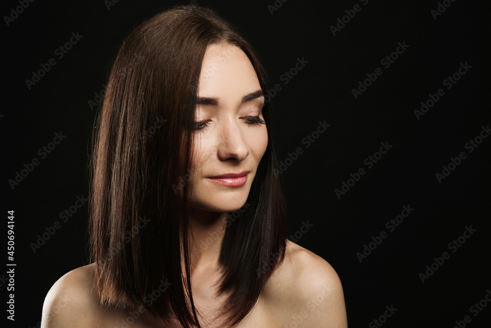 Portrait of pretty young woman with gorgeous chestnut hair on black background, space for text Portrait of pretty young woman with gorgeous chestnut hair on black background, space for text