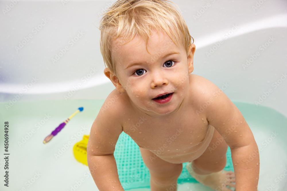 Baby boy bathing with colorful water toys Baby boy bathing with colorful water toys