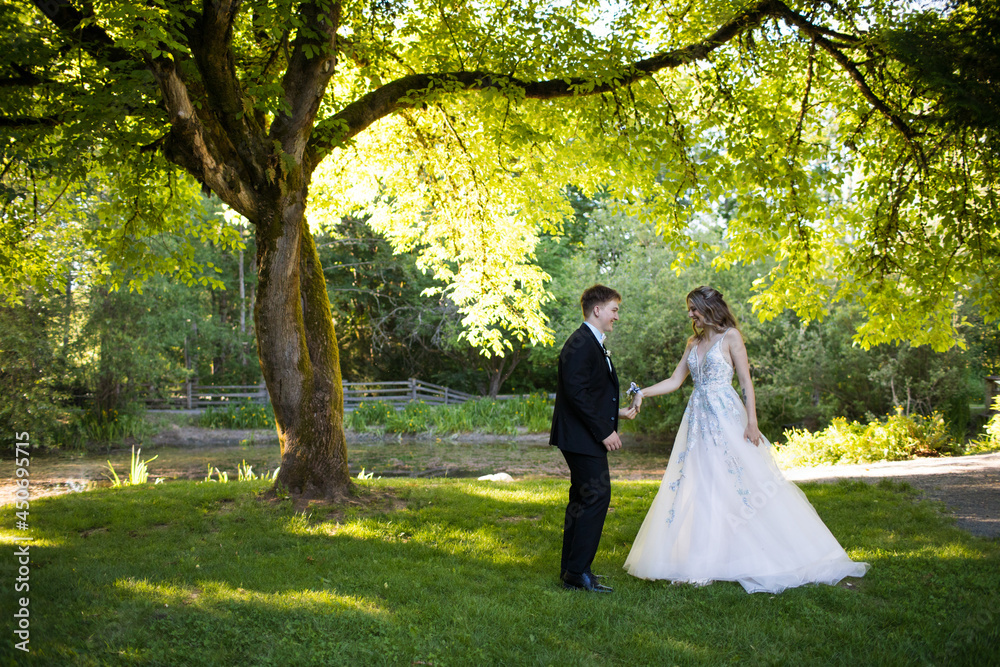 Young couple prepare to dance under large tree in nature. Young couple prepare to dance under large tree in nature.
