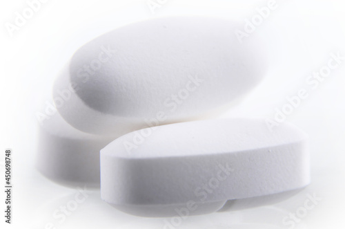 Composition with pharmaceutical drug pills over white background