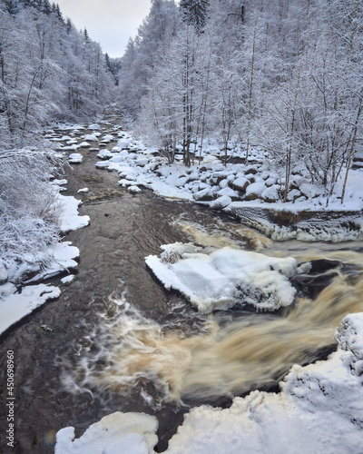 Rapids of the Nukarinkoski Vantaanjoki river in Nurmijarvi in winter in Finland. photo