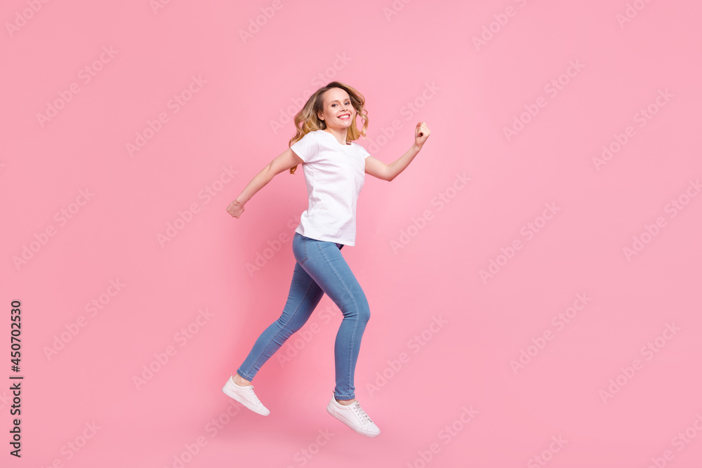 Full length body size photo girl wearing stylish clothes jumping running on sale isolated pastel pink color background