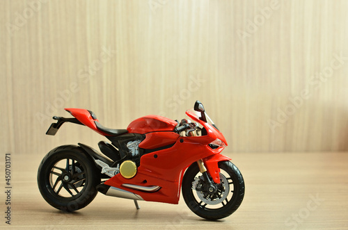 Red motorcycle toy in with background