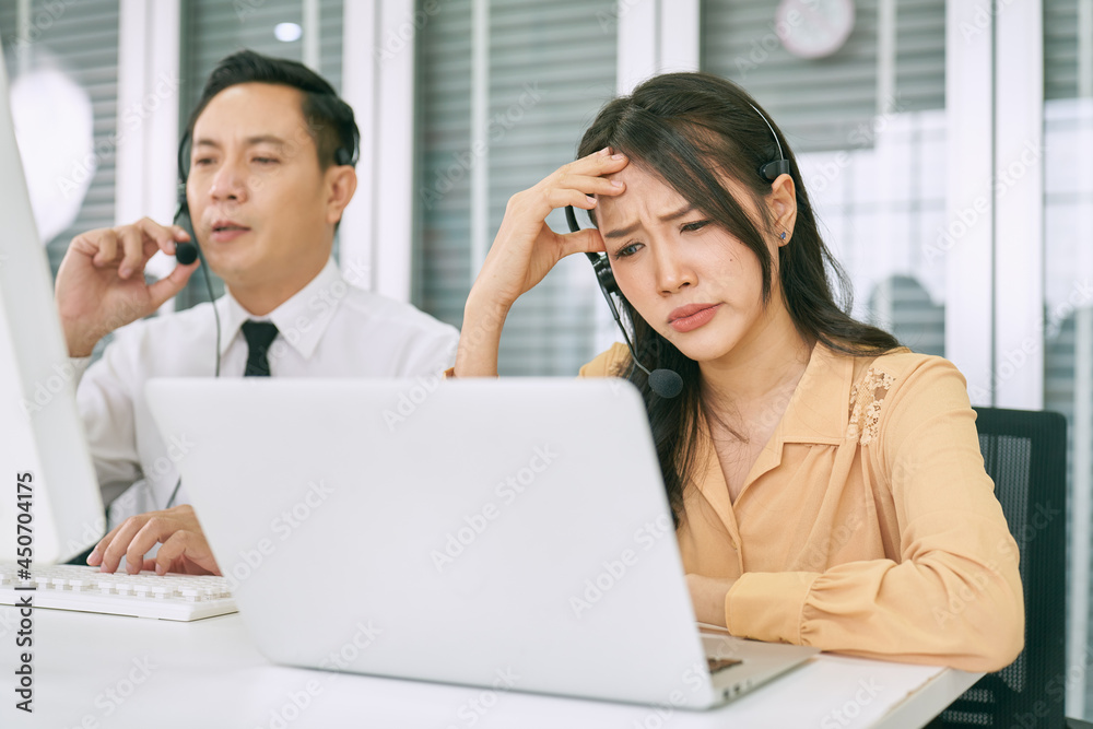 Asian female call center have problem and serious face from helping customer issues Asian female call center have problem and serious face from helping customer issues