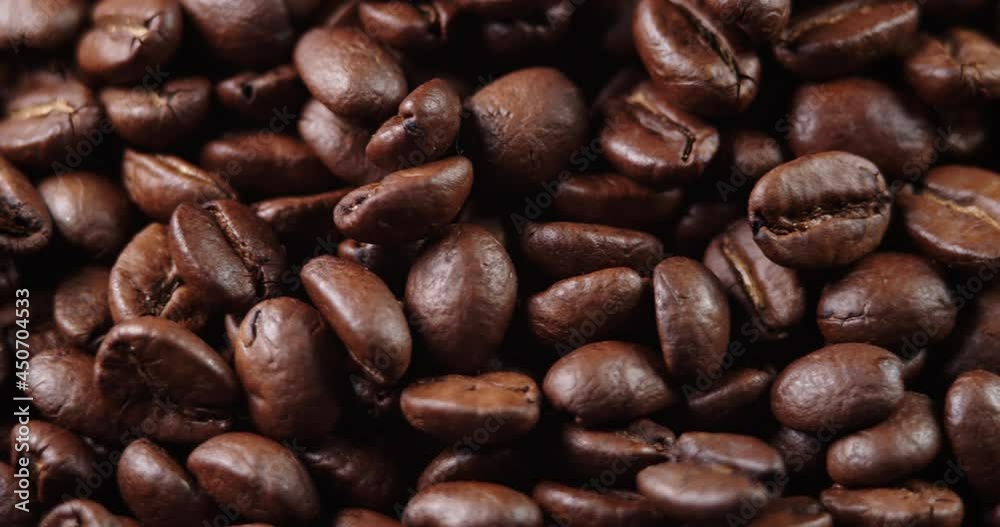 Roasted coffee bean. Fragrant coffee beans scrolls slowly around the camera. Slow Motion Close Up of Whole Roasted Coffee Beans. Roasted coffee bean. Fragrant coffee beans scrolls slowly around the camera. Slow Motion Close Up of Whole Roasted Coffee Beans.