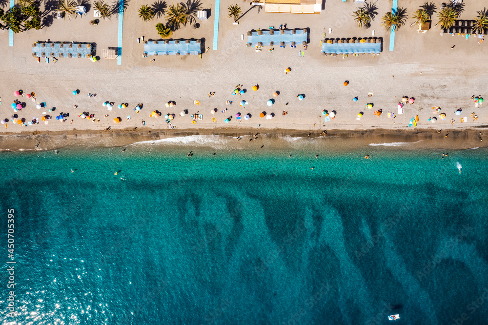 Aerial view of the sea and many people on the beach in Spain