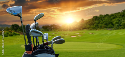 The Golf club bag and golf balls on green grass for golfer training with golf course background,green tree sun rays.	
 photo