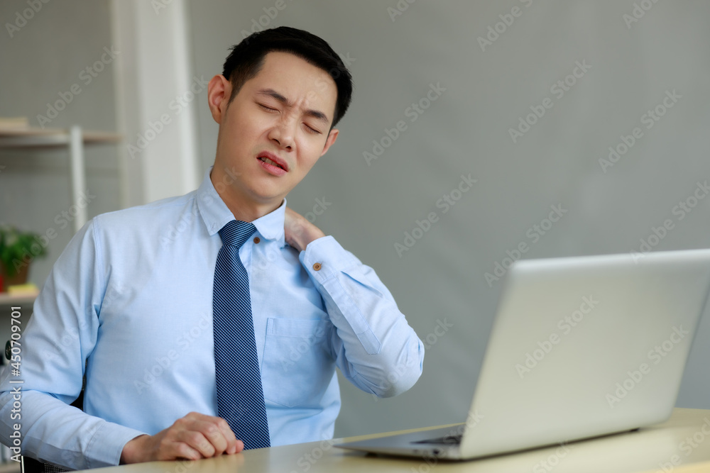 Asian businessman sitting working hard with office syndrome have problem with part of body arm shoulder while working Asian businessman sitting working hard with office syndrome have problem with part of body arm shoulder while working