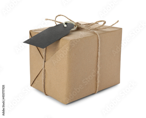 Parcel wrapped in kraft paper with tag on white background