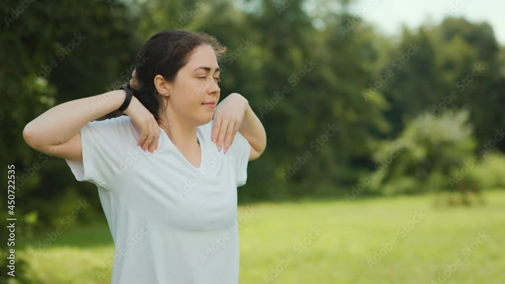 Outdoors warmup. Portrait of young beautiful woman doing warm-ups in the park. Pan shot. Slow motion. Sport and wellness concept. Outdoors warmup. Portrait of young beautiful woman doing warm-ups in the park. Pan shot. Slow motion. Sport and wellness concept.