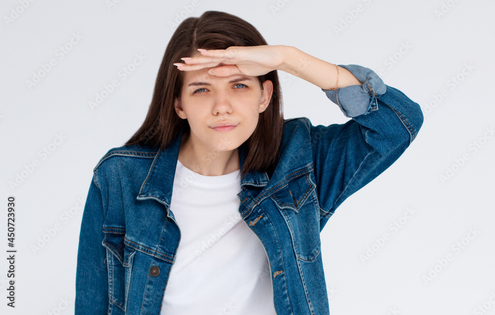 Young pretty woman with brown hair looking far isolated on white background Young pretty woman with brown hair looking far isolated on white background