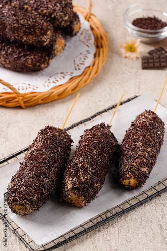 Delicious homemade Donat paha ayam, Donat paha ayam is a traditional snack in Indonesia. 

Donuts are shaped like chicken thighs and covered with chocolate sprinkles photo