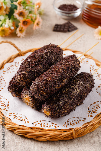 Delicious homemade Donat paha ayam, Donat paha ayam is a traditional snack in Indonesia. 

Donuts are shaped like chicken thighs and covered with chocolate sprinkles photo